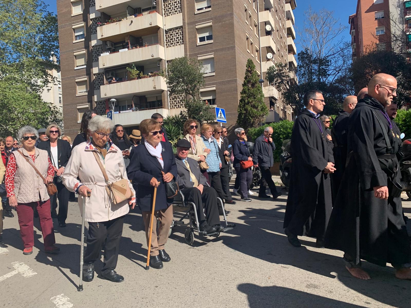 Feligresos seguint la processó a l'altura del Mercat de Serraperera