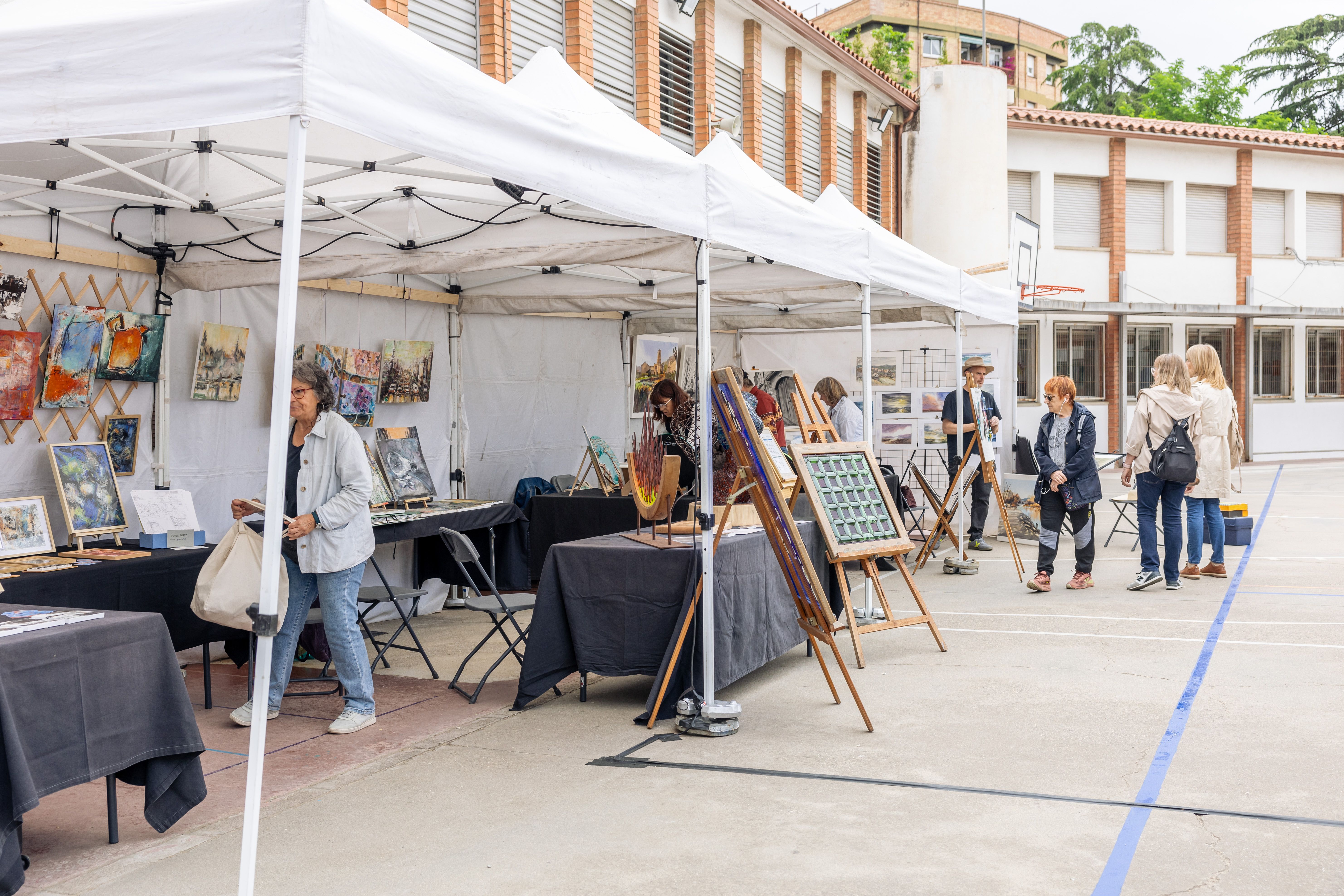 Vista general de la fira d’art amb públic visitant els estands. FOTO: Arnau Padilla