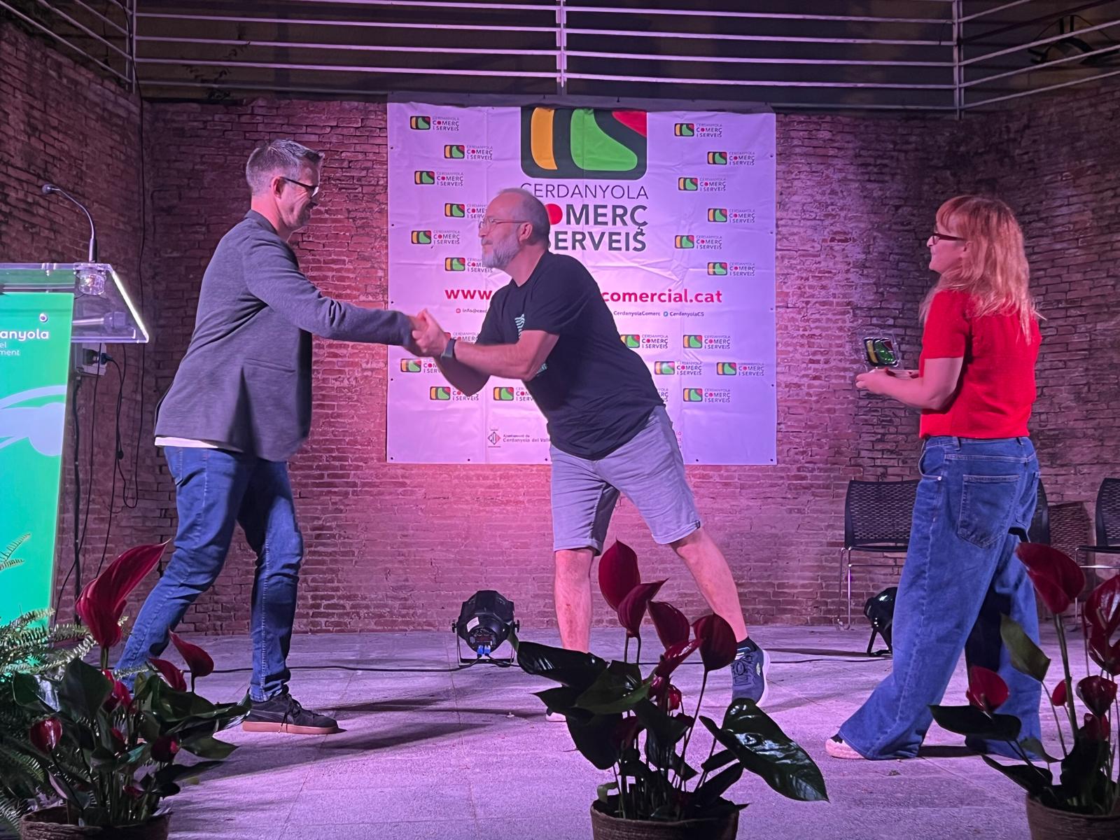 Xavi Olivé, president de Cerdanyola Comerç i Serveis, lliura a Joan Prófumo, de Tempo di Vino, el reconeixement de Comerç Ambaixador de CCS, acompanyats de Núria Nájera, secretària de l'entitat. FOTO: Judit Josa
