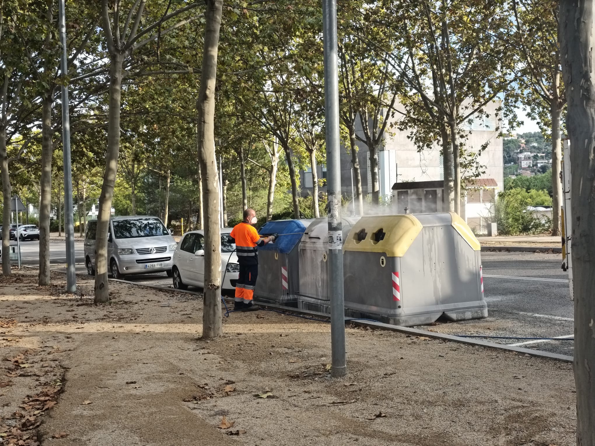 Un operari neteja els contenidors al carrer dels Boters, prop del cementiri i el tanatori municipals, el 21 d'octubre, el mateix dia que l'alcalde Carlos Cordón anunciava l'inici imminent del contracte d'emergència de residus. FOTO:  Lola Morral